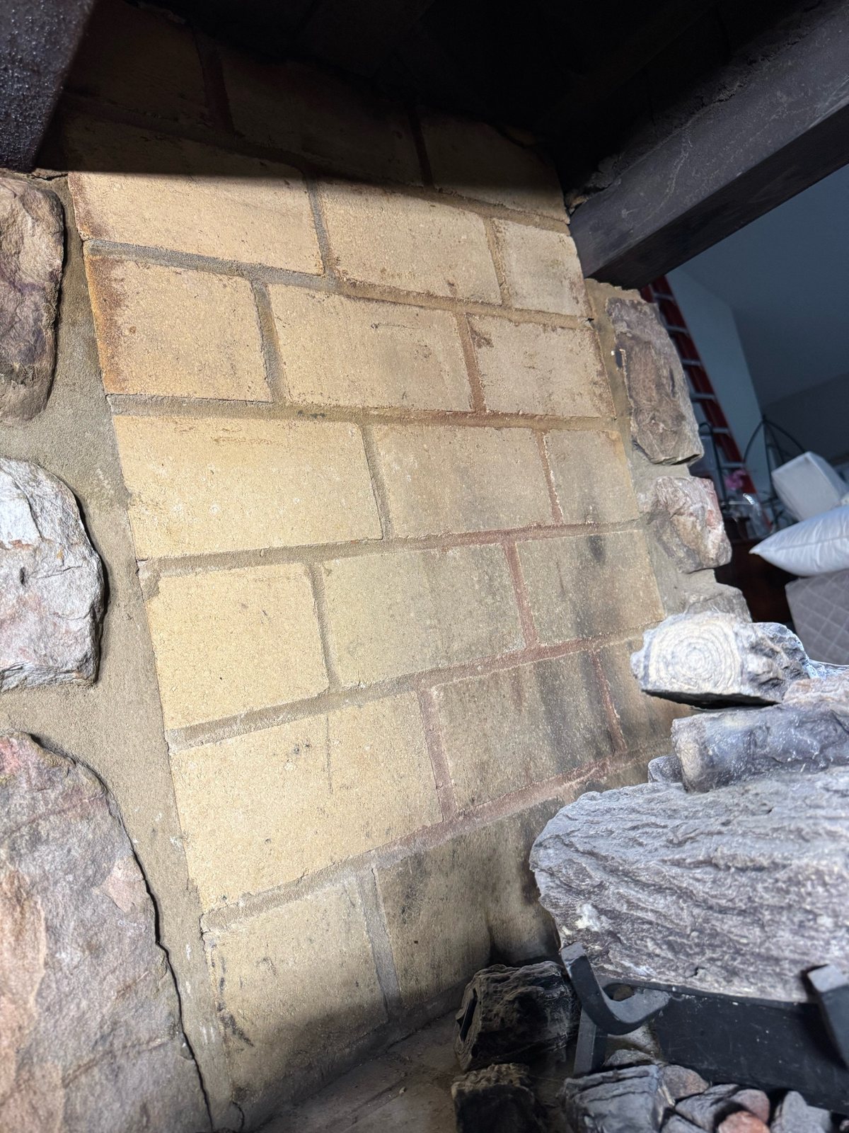 Opposite side of the fireplace firebox after targeted soot removal